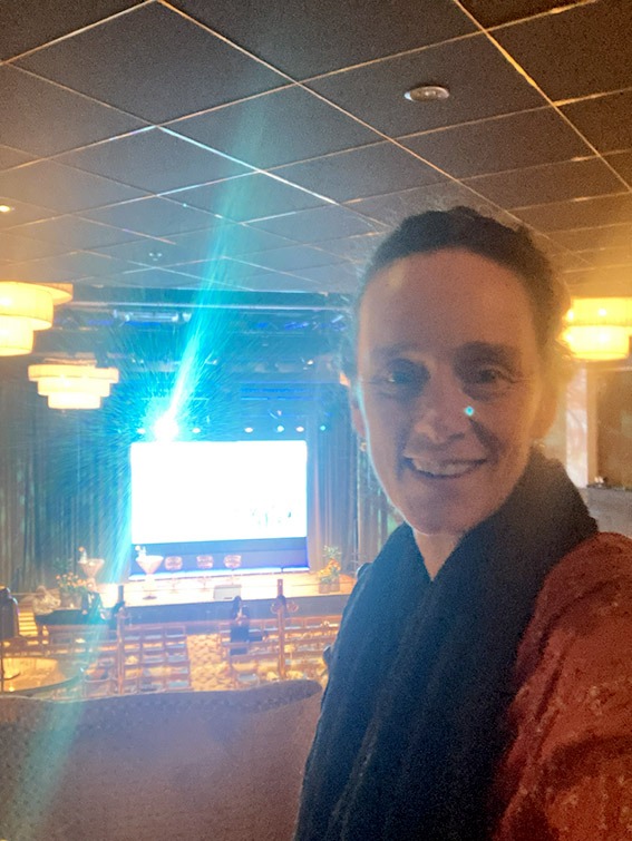 Megan van der Ley selfie at large conference venue.